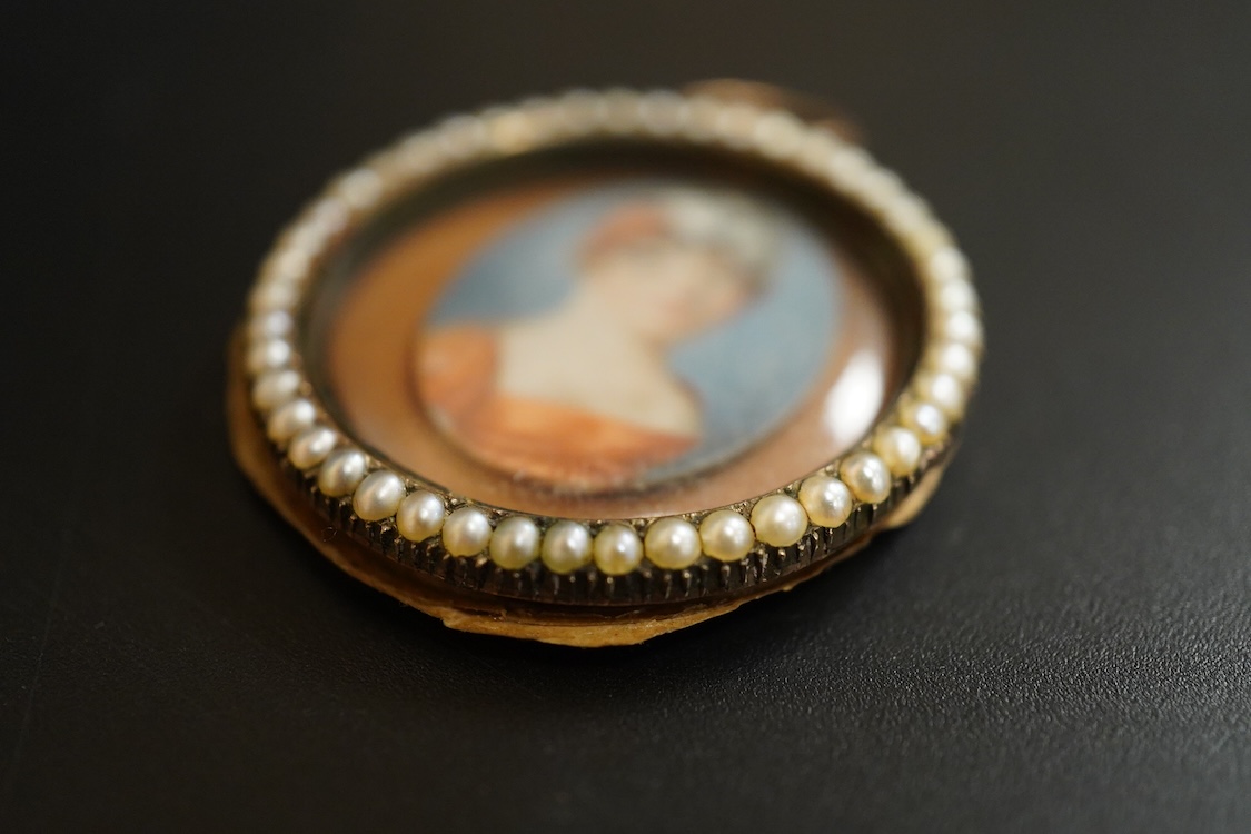 Regency School, Oval portrait miniature of a lady, watercolour on ivory, housed in a split pearl and yellow metal frame (untested) inscribed Anne Groves?, obt. 1800, aged 48, 3.5cm in diameter IVORY SUBMISSION L8EYBNUP